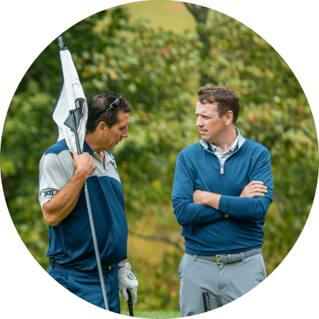 Two golfers talking on the green